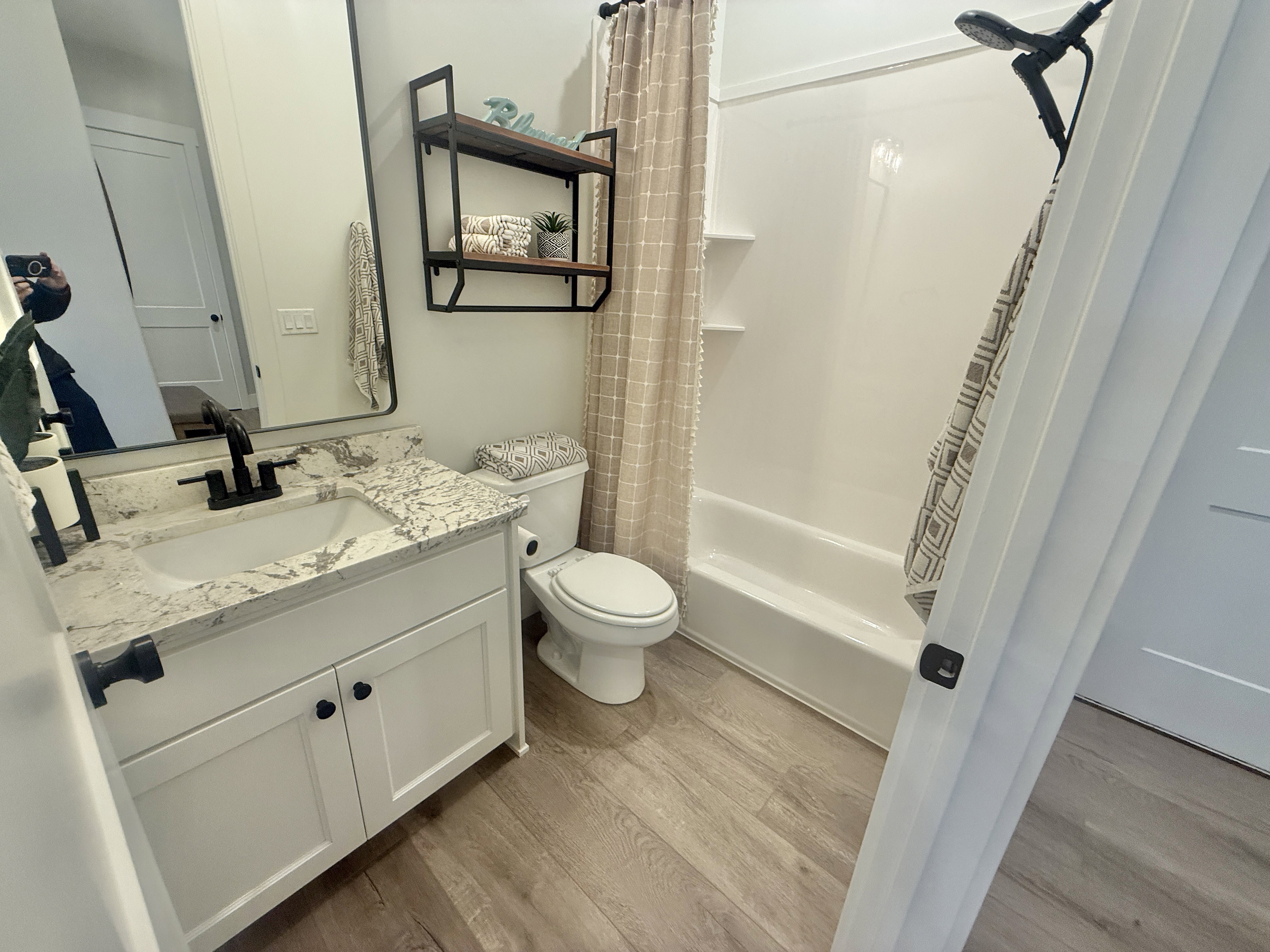 Full bath with vanity, light wood-style flooring, and shower / bathtub combination with curtain