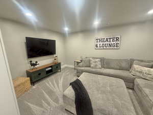 Living area featuring light carpet and recessed lighting