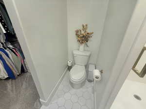 Bathroom with toilet and light tile patterned floors