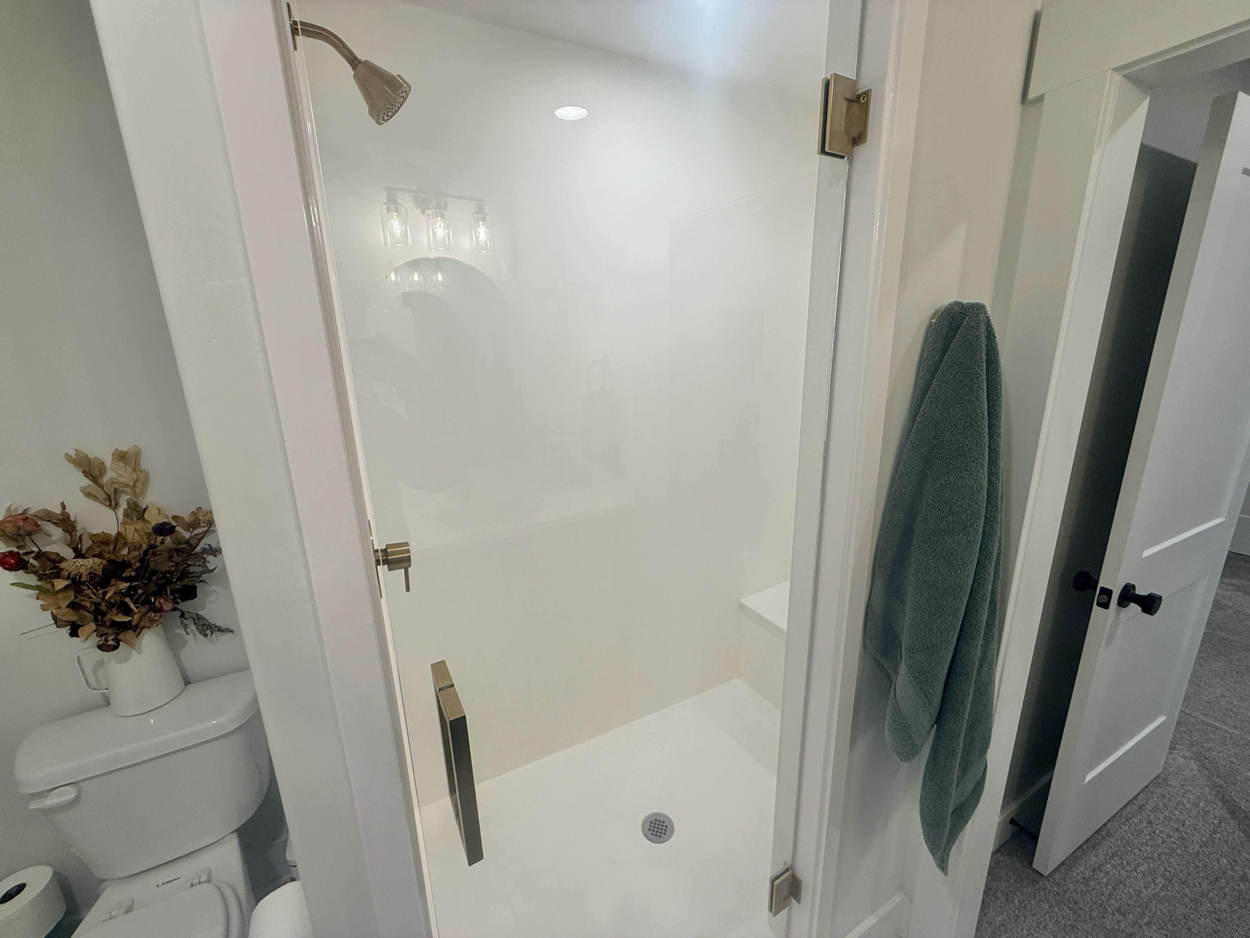 Full bath with a shower stall and toilet