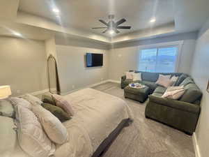 Bedroom featuring a tray ceiling, carpet floors, a ceiling fan, and recessed lighting