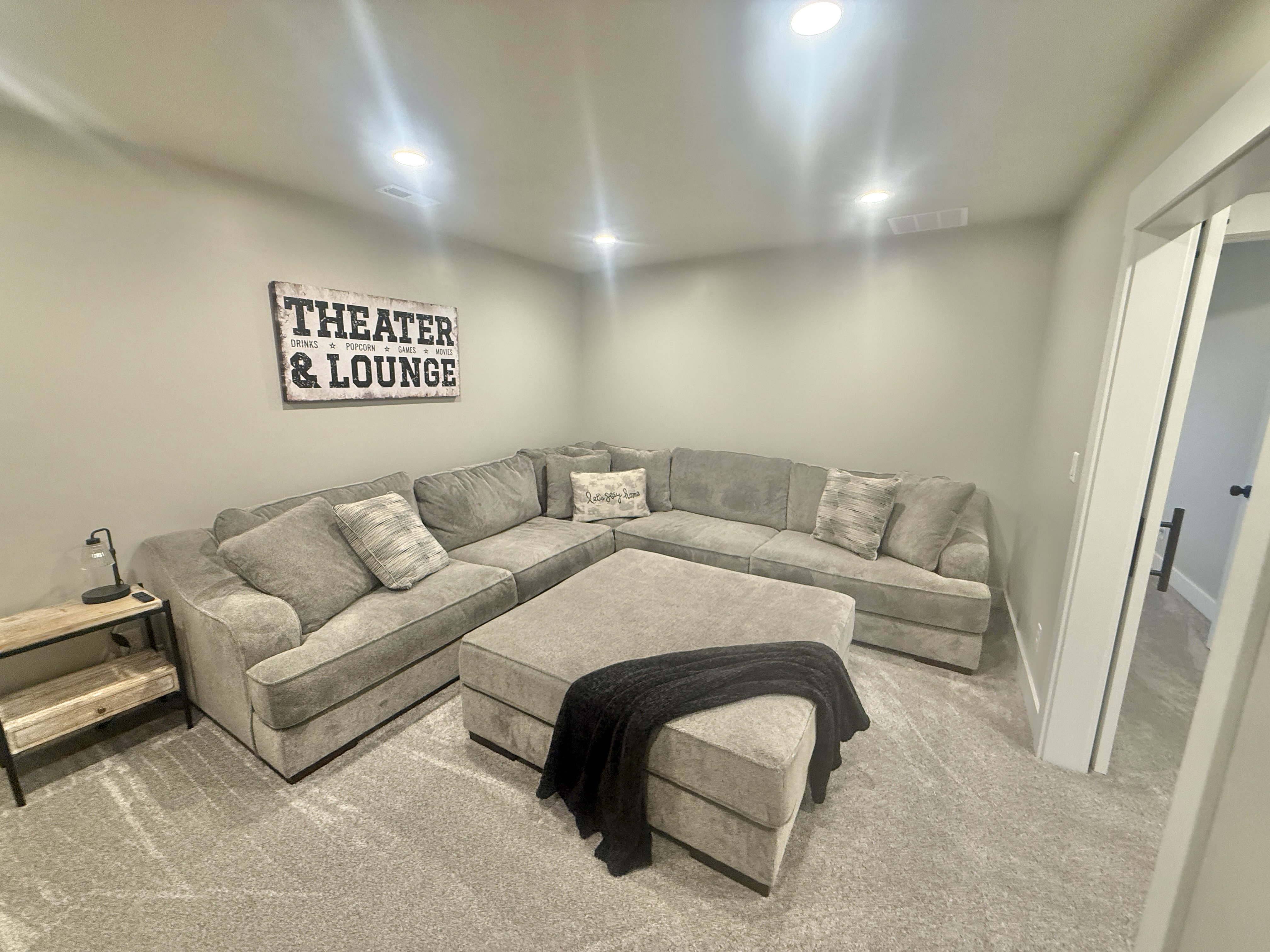 Carpeted living room featuring baseboards and recessed lighting