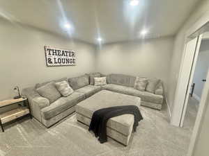Carpeted living room featuring baseboards and recessed lighting