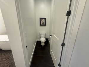 Bathroom with toilet and baseboards