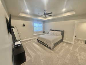 Bedroom featuring light carpet, ceiling fan, and recessed lighting