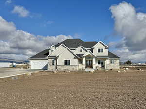 Craftsman house with stone siding, roof with shingles, a garage, and concrete driveway
