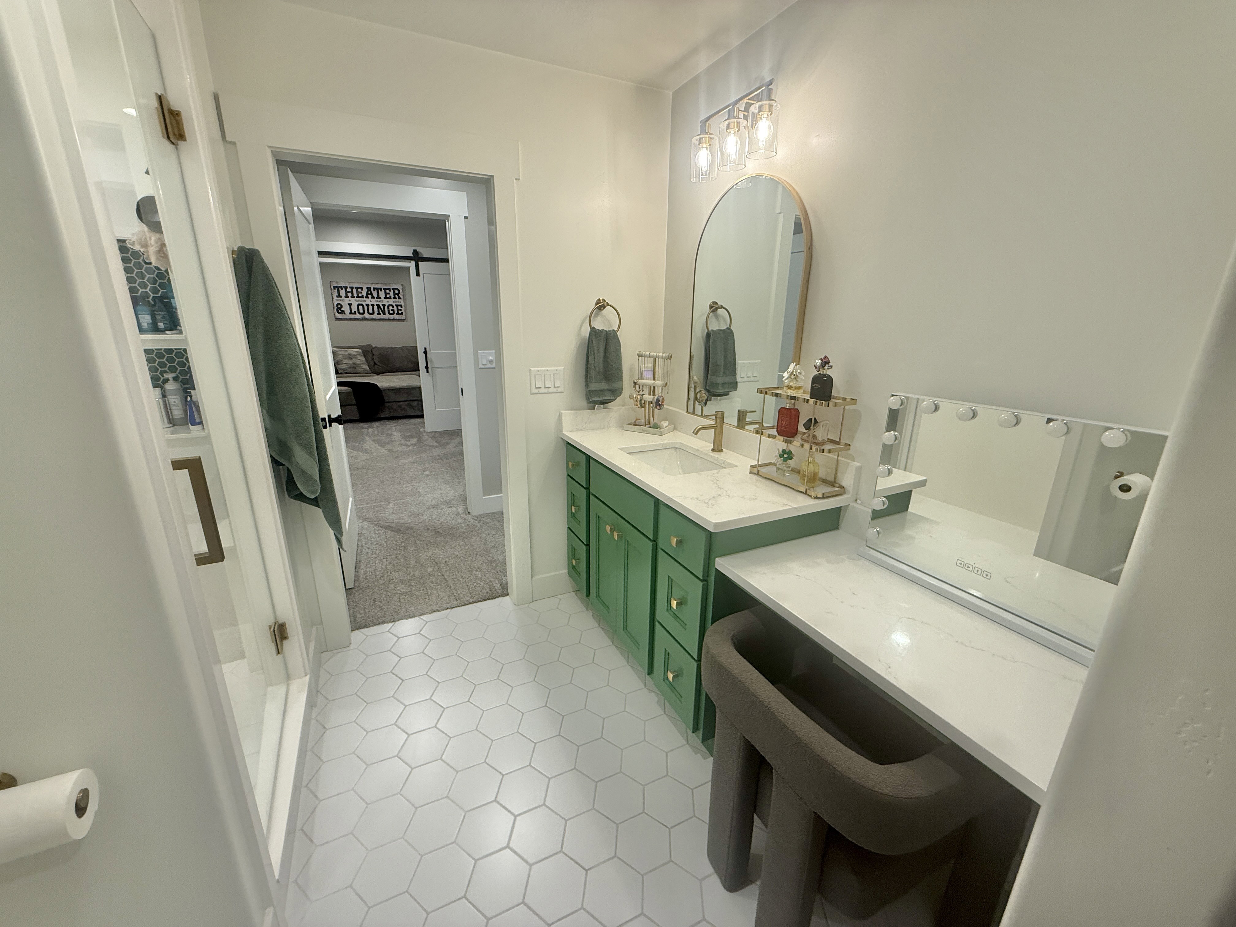 Full bath featuring vanity, light colored carpet, and ensuite bath