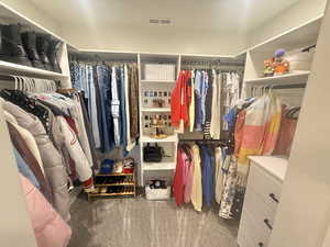 Walk in closet featuring dark colored carpet