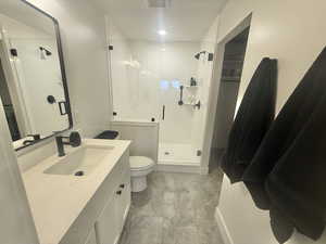 Bathroom featuring vanity and a stall shower