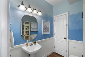 Bathroom with toilet and wood finished floors
