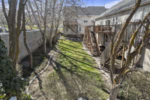 Fenced yard featuring a wooden deck and stairs