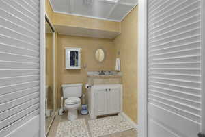 Half bathroom featuring vanity and light tile patterned floors