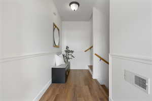 Entry hall with dark wood-type flooring and baseboards