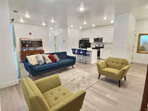 Living room with light wood-style flooring