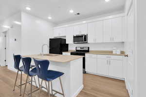 Kitchen with island and white cabinetry