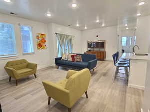 Living room featuring light wood-style flooring and recessed lighting