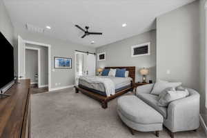 Bedroom featuring a barn door, carpet flooring, recessed lighting, and a ceiling fan