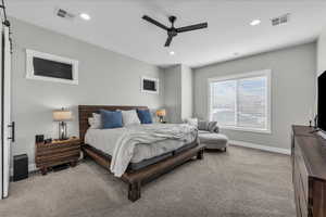 Carpeted bedroom with ceiling fan and recessed lighting