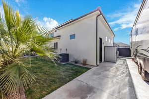 View of home's exterior with stucco siding and a lawn