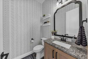 Bathroom with vanity and a closet