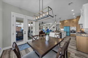 Dining room featuring recessed lighting, french doors, light wood finished floors, and a ceiling fan