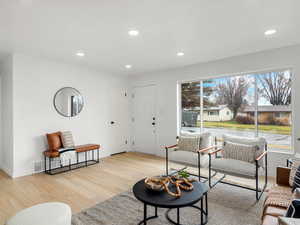 Living area with recessed lighting and light wood finished floors