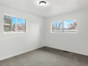 Empty room with baseboards and carpet flooring