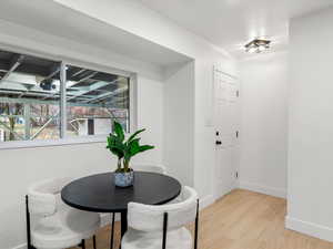 Dining room featuring light wood finished floors and baseboards