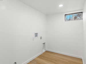 Laundry room featuring light wood-style floors, washer hookup, and recessed lighting
