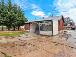 View of outdoor structure with driveway