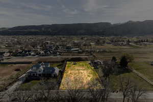 Aerial view of property's location featuring a mountainous background and property parcel outlined