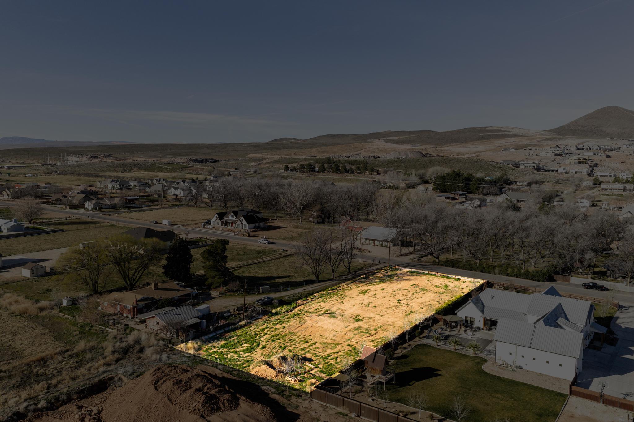 Aerial perspective of suburban area with a mountainous background