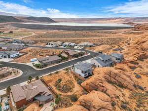 Aerial view of residential area featuring a desert landscape and a mountainous background