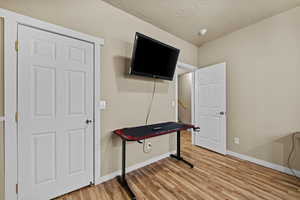 Bright bedroom with large window and plenty of space for furniture and personal touches.