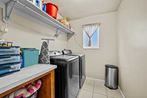 Convenient main-level laundry room with storage shelving and natural light.