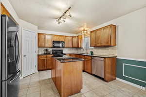 Functional kitchen with ample cabinet space, center island, and updated finishes.
