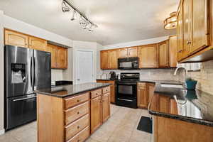 Kitchen featuring generous counter space, island seating, and stainless appliances.