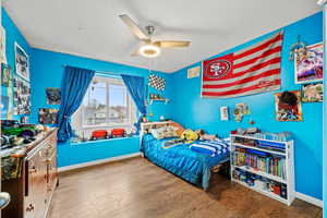 Bright secondary bedroom with large window and plenty of space for furniture and personal touches.