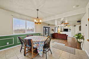 Dining area with large window and open concept layout connecting to the family room.