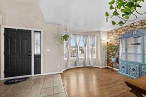 Welcoming front entry with large bay windows bringing in natural light.
