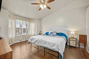 Spacious primary bedroom featuring vaulted ceilings and beautiful bay windows for abundant natural light.