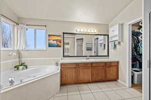 Spacious primary bathroom with large vanity, soaking tub, and plenty of natural light.