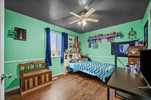 Spacious bedroom with large window and plenty of room for furniture or study space.