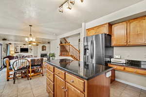 Spacious kitchen with center island, stainless appliances, and open flow to the dining and living areas.