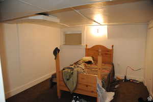 Carpeted bedroom featuring baseboards