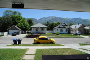 View of yard featuring a mountain view, a residential view, and an outbuilding
