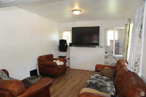 Living area with wood finished floors and baseboards