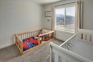 Carpeted bedroom with a crib