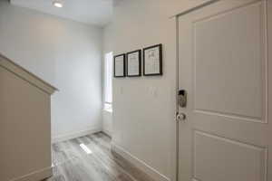 Foyer featuring light wood finished floors and recessed lighting