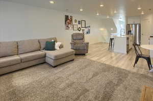 Living area featuring recessed lighting and light colored carpet
